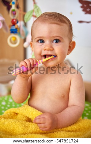 Similar – Happy adorable infant baby boy child smiling while eating two frozen fruit popsicle ice creams in simmer.