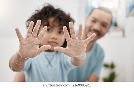 First We Rub With Soap, Then We Rinse. Portrait Of A Little Boy Holding Up His Soapy Hands While Standing In A Bathroom With His Father At Home.