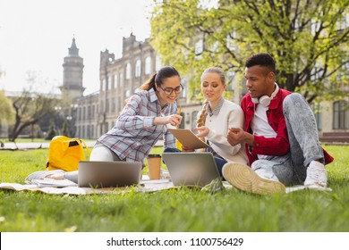 First Year. First Year Students Feeling Curious While Looking At Their University Schedule Sitting Outside