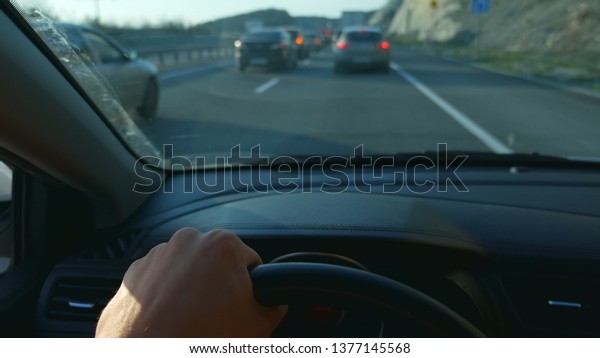 first-person view.\
Driving a car in rush\
hour
