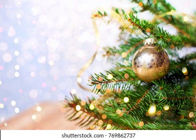 Fir-tree spruce with Christmas golden decor balls. Holiday background.