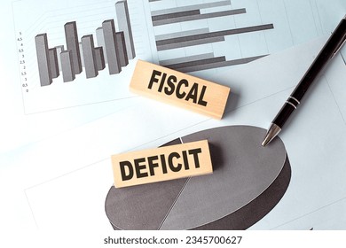 FISCAL DEFICIT wooden block on a chart background