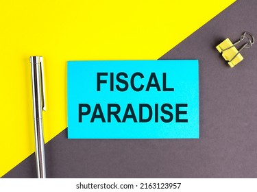 FISCAL PARADISE text written on a sticky with pen on grey, yellow background, business concept