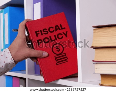 Fiscal policy written on the book. The financial data visible in the background
