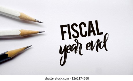 Fiscal Year End Memo Written On A White Background With Pencils