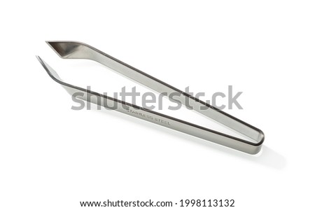 Fish bone remover tongs isolated on white background. Stainless steel tweezers for removing small bones along the fish spine. Kitchen metall forceps close-up. Fishbone pincers macro. Kitchen utensils.