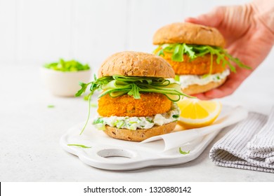 Fish Burger With Cucumber, Arugula And Mayonnaise Sauce, White Background, Vegetarian Food.