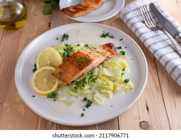 Fish With Cabbage And Bechamel Sauce On A Plate