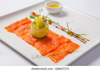 Fish carpaccio. Carpaccio of salmon on white plate.