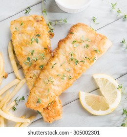 Fish And Chips. Above View Fried Fish Fillet With French Fries On Wooden Background.