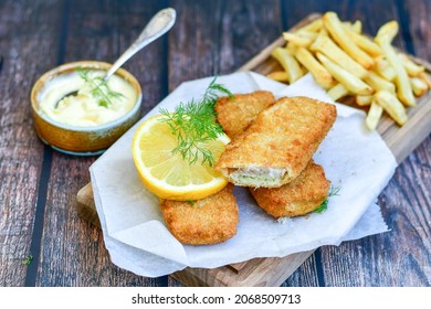  Fish And Chips .Close Up Of   Crispy Breaded  Deep Fried Fish Fingers With Breadcrumbs Served With Remoulade Sauce And  Lemon