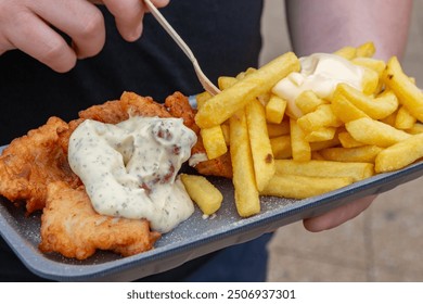 fish and chips, deep fried cod and potato chips, fries with mayo and sauce - Powered by Shutterstock