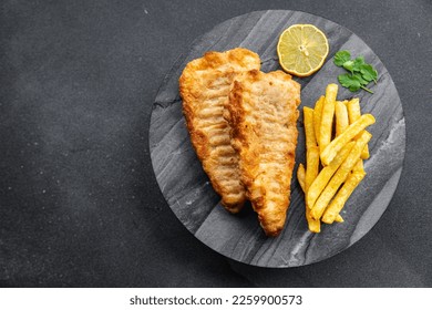 fish and chips french fries deep fried fast food takeaway healthy meal food snack on the table copy space food background rustic top view - Powered by Shutterstock