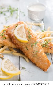 Fish And Chips. Fried Fish Fillet With French Fries On Bright Wooden Background. Fresh Cooked With Hot Steams Smoke.