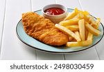 Fish and chips is a hot dish of fried fish in batter, served with chips or french fries.  Malt vinegar, ketchup,  catsup, tartar sauce are common dipping sauces.  isolated on white background