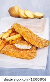 Fish and chips on wooden background. Fried and fresh fillet, and potatoes.Traditional english eating.