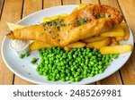 Fish and chips with peas and mayonnaise - traditional UK food