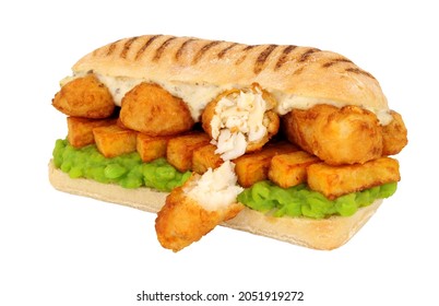 Fish And Chips Sandwich With Battered Cod Fish And Mushy Peas In A Panini Bread Roll Isolated On A White Background