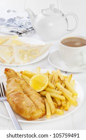 Fish And Chips Served With Buttered Bread And A Pot Of Tea. Favourite British Seaside Supper.