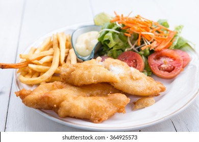 Fish And Chips Served With Salad And Sauce