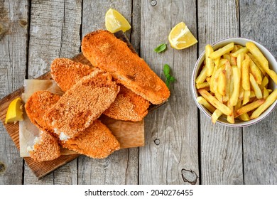 Fish And Chips.Crispy  Breaded  Fish Fillets  And French  Fries  On Woodn Background 