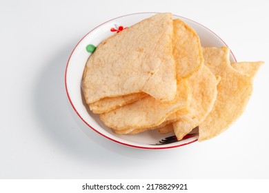 Fish crackers or prawn crackers in a plate on a white background - Shutterstock ID 2178829921