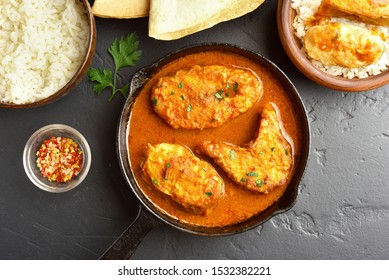 Fish Curry In Pan On Black Stone Table. Indian Style Food. Top View, Flat Lay