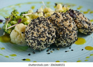 Fish Cutlets In Sesame Seeds With Broccoli And Cauliflower. Keto Menu For Restaurant. Fishcake With Vegetable Mix On Stone Table. Healthy Fish Dish For Diet. Salmon Cutlet In Blue Plate