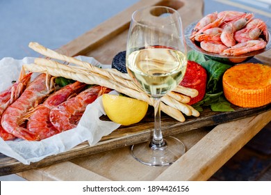 Fish Delicacys For Wine On Wood Plate