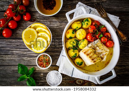 Similar – Image, Stock Photo Cod fillet with lemon slices and herbs