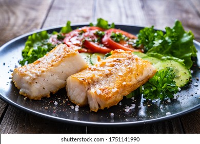 Fish Dish - Fried Cod Fillet With Vegetables On Wooden Table