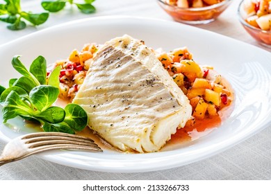 Fish Dish - Fried Cod Fillet With Fresh Fruit Salsa On White Table 