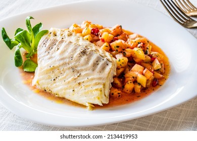 Fish Dish - Fried Cod Fillet With Fresh Fruit Salsa On White Table 