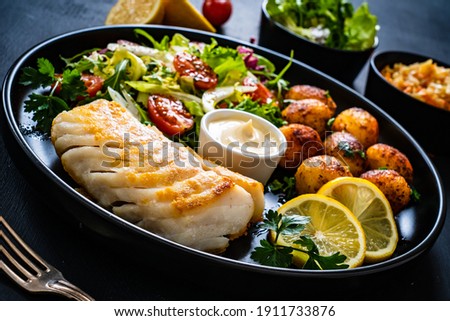 Similar – Image, Stock Photo Cod fillet with lemon slices and herbs