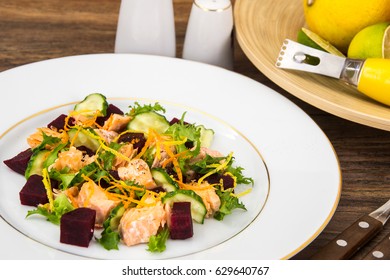 Fish dishes, salad with salmon and beets. Studio Photo