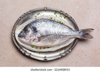 Fish Dorado Or Sea Bream With Aromatic Herbs Ready To Be Cooked On A Silver Dish.