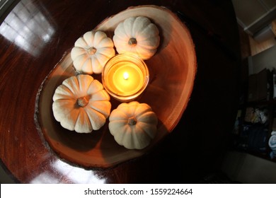 Fish Eye Lense Picture Of A Candle In Little Pumpkins