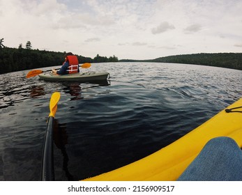 A Fish Eye Photo From The Boat Of A Rower On A Boat In The Lake And A Forest