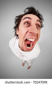 Fish Eye Shot Of Screaming Insane Man In Strait-jacket On Grey Background