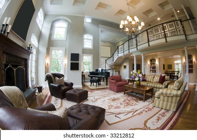 Fish Eye Wide Angle View Of Living Room With Fireplace And Grand Piano And French Doors In Luxury Estate Mansion Home