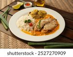 FISH FILLET WITH MOQUECA SAUCE AND COCONUT RICE, TYPICAL BRAZILIAN DISH TOP VIEW