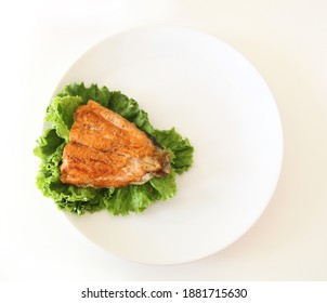 Fish Fillet On Salad. White Plate