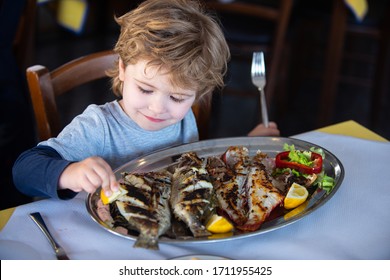 Fish For Food. Child Wuth Lemon And Fish Plate Meal. Dinner In Sea Restaurant. Seafood With Iodine For A Healthy Diet Eating.