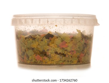 Fish Food Flakes In A Container Isolated On A White Background