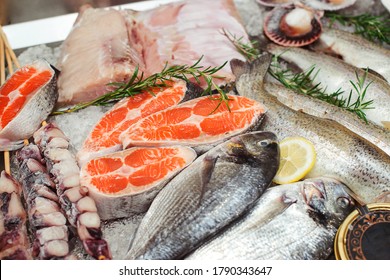 Fish food at shop, close up. Raw fish ready for sale in the supermarket. Showcase with chilled red fish in grocery store. Market place, showcase with sea food. Retail sale, marketplace.