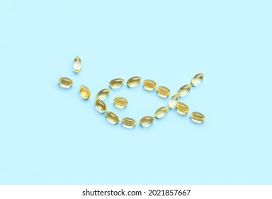 Fish Made Of Oil Capsules On Color Background