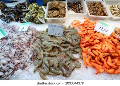 Fish Market At Boqueria Market In Barcelona, Spain. Fresh Sea Food - Squids, Prawns, Shrimp And Shellfish.