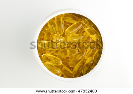 Fish oil capsules in white plastic canister on white background