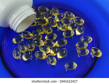 Fish Oil Food Joint And Heart Canine Supplements For Older Dogs And For Dog Athletes On Blue Plate With White Bottle