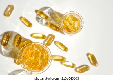 Fish Oil Gelatin Capsules In Laboratory Transparent Flasks On A White Background.Healthy Eating And Food Supplements.omega Fatty Acids.Natural Supplements And Vitamin